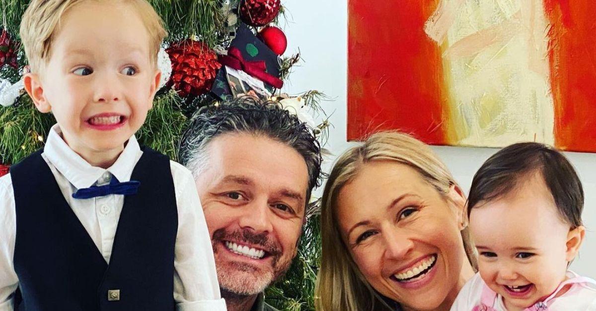 Jock Zonfrillo's son, Jock Zonfrillo, Laura Fried, and Jock Zonfrillo's daughter smiling by a Christmas tree. 